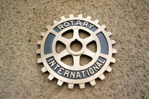 Rotary-International-Abzeichen, auf einer braunen Mauer hängend